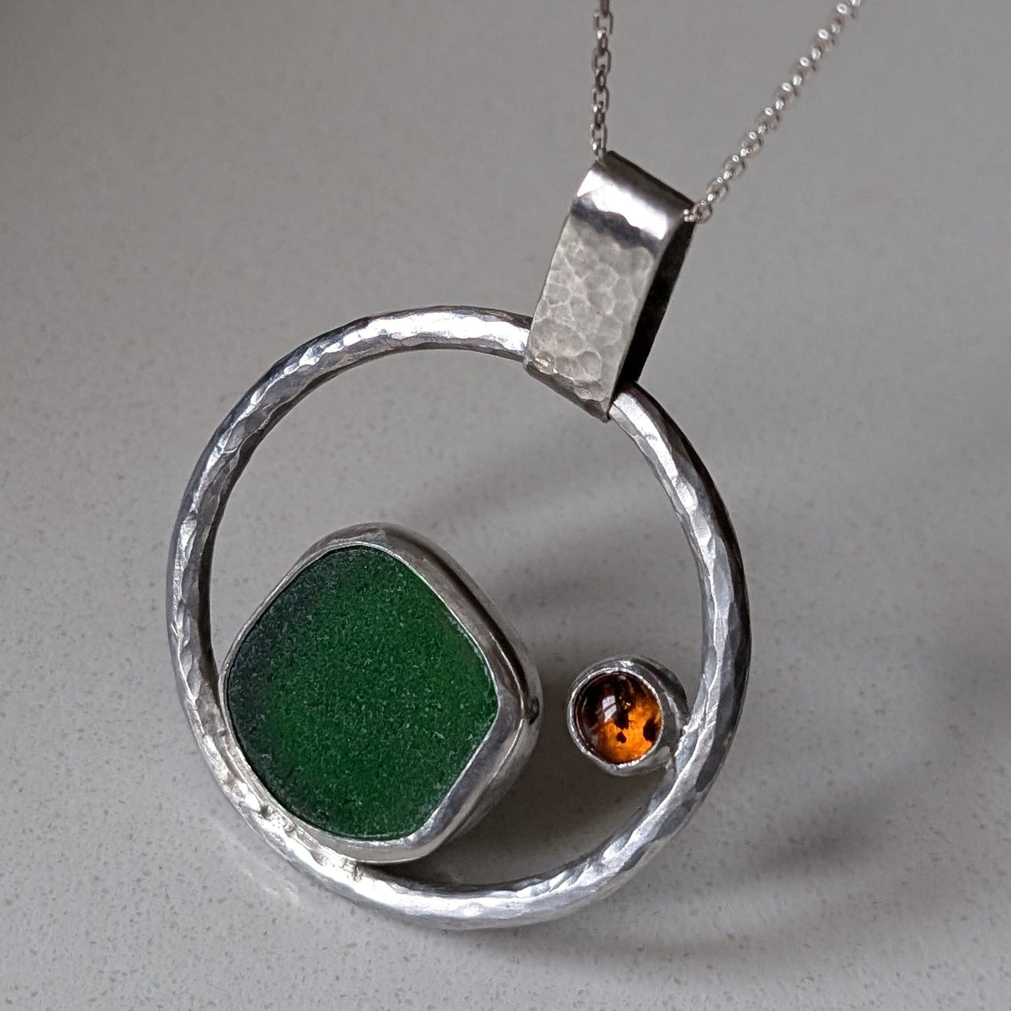 Handmade green sea glass necklace with 100% recycled sterling silver.