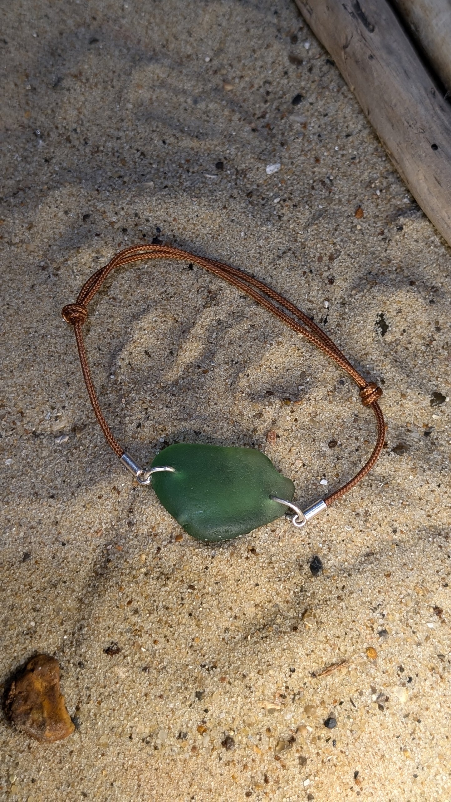 Adjustable cord bracelet with green sea glass