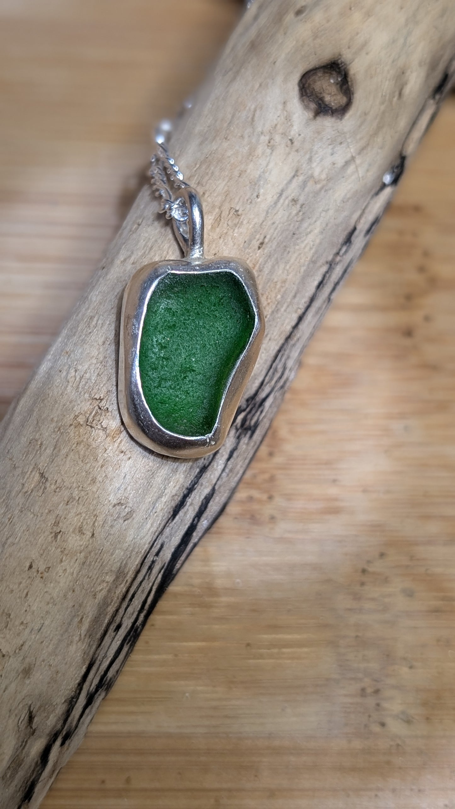 Green sea glass pendant encased in bezel with chain