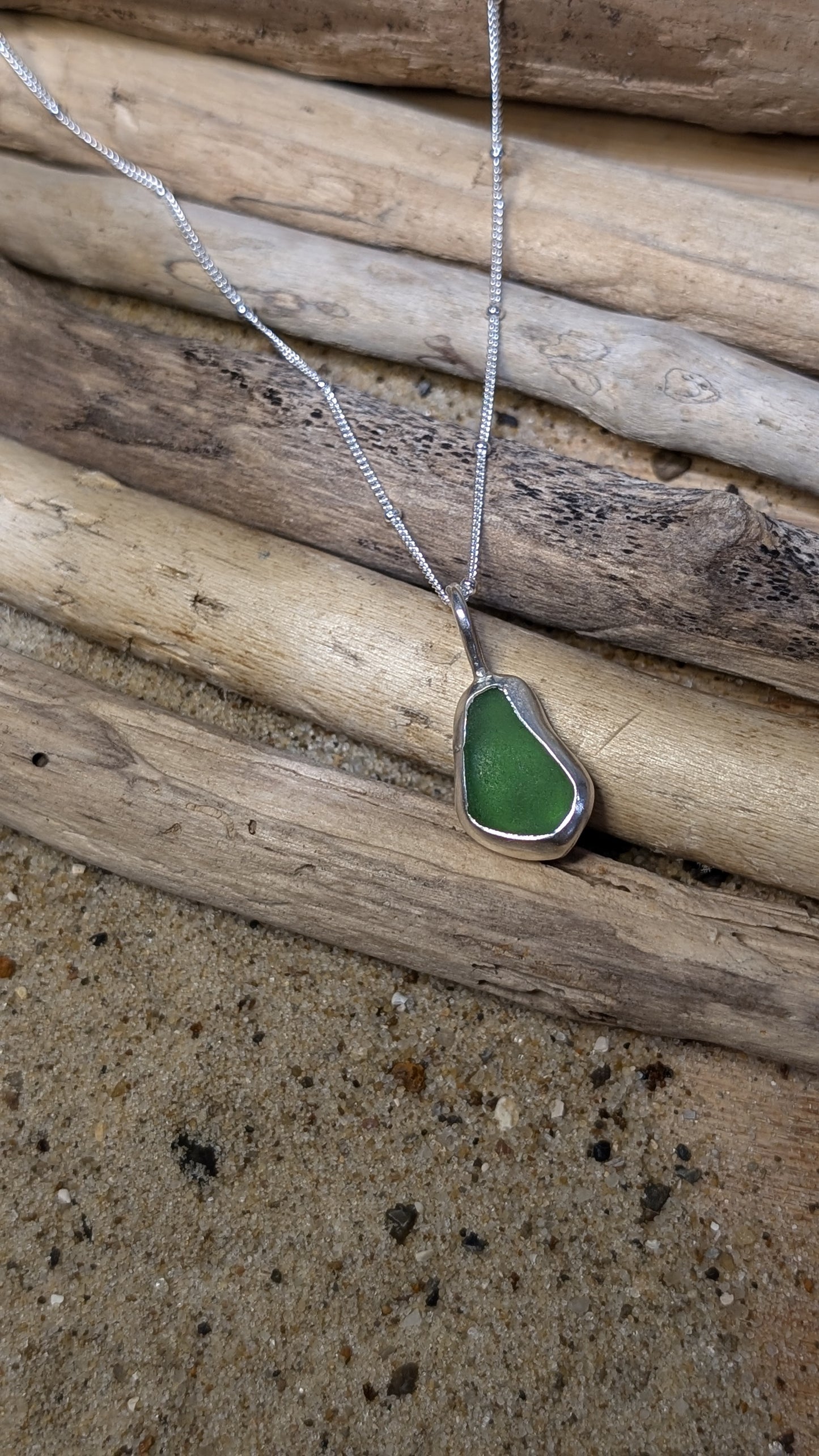 Green sea glass pendant encased in bezel with chain