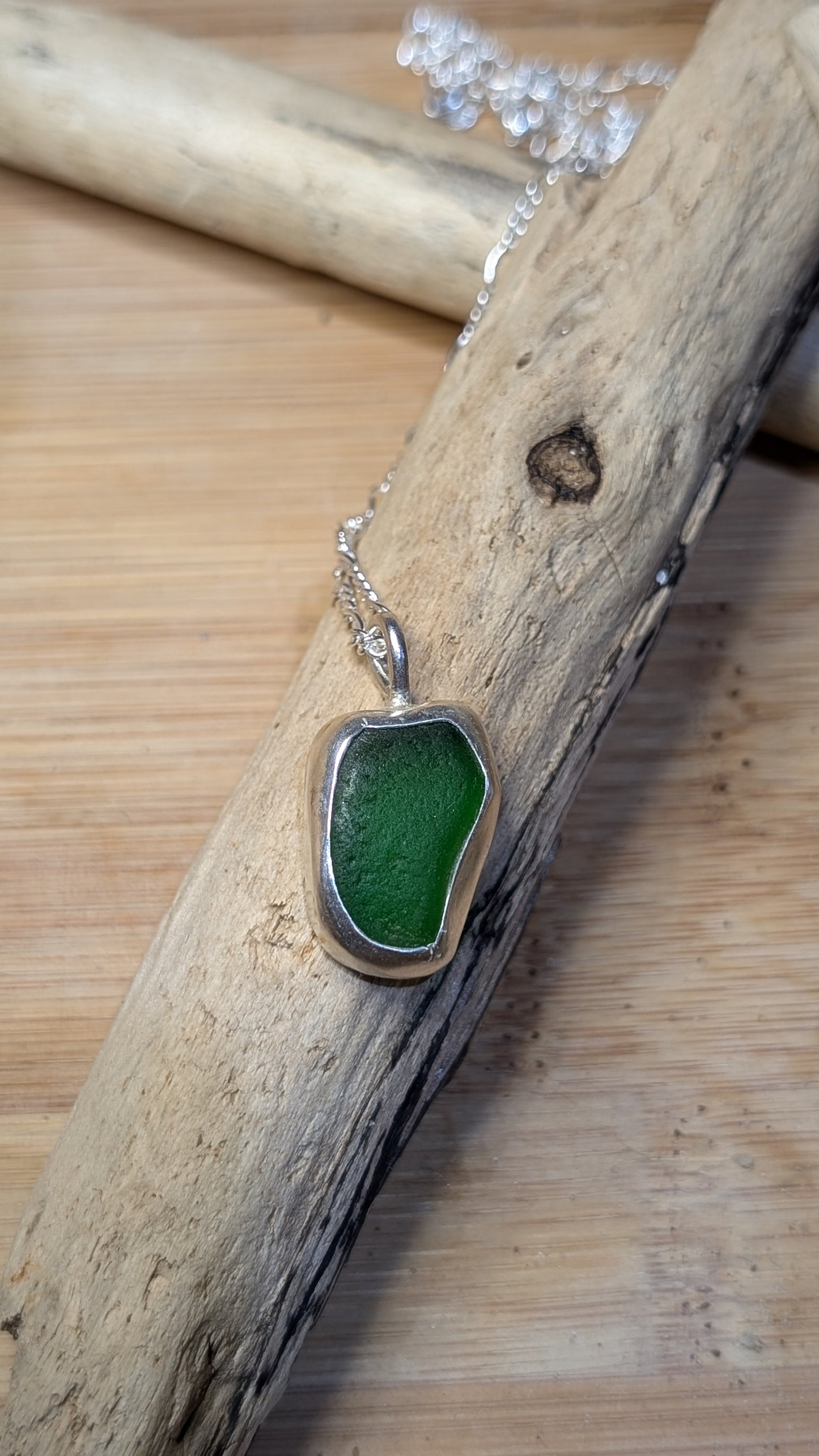 Green sea glass pendant encased in bezel with chain
