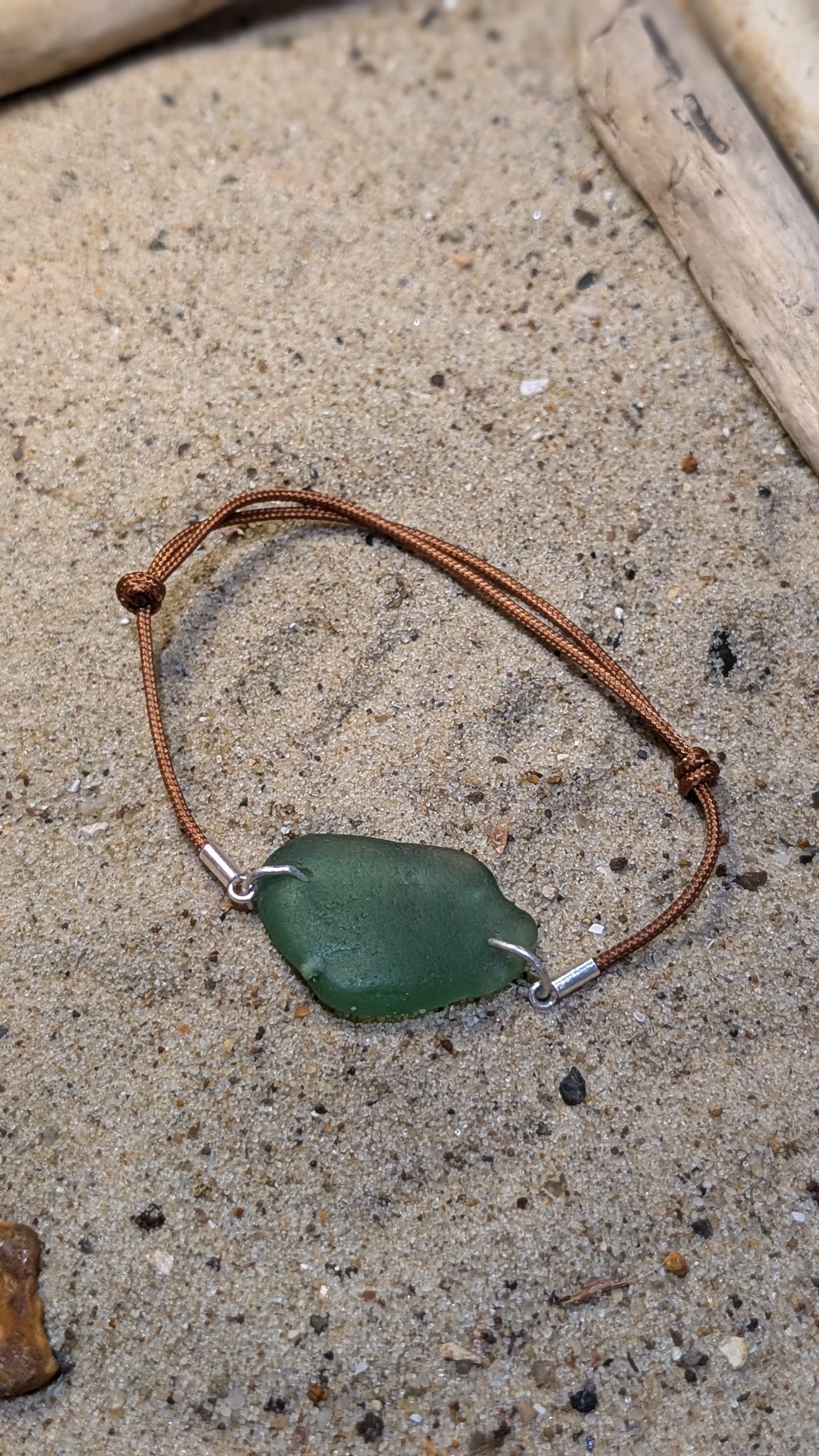 Adjustable cord bracelet with green sea glass