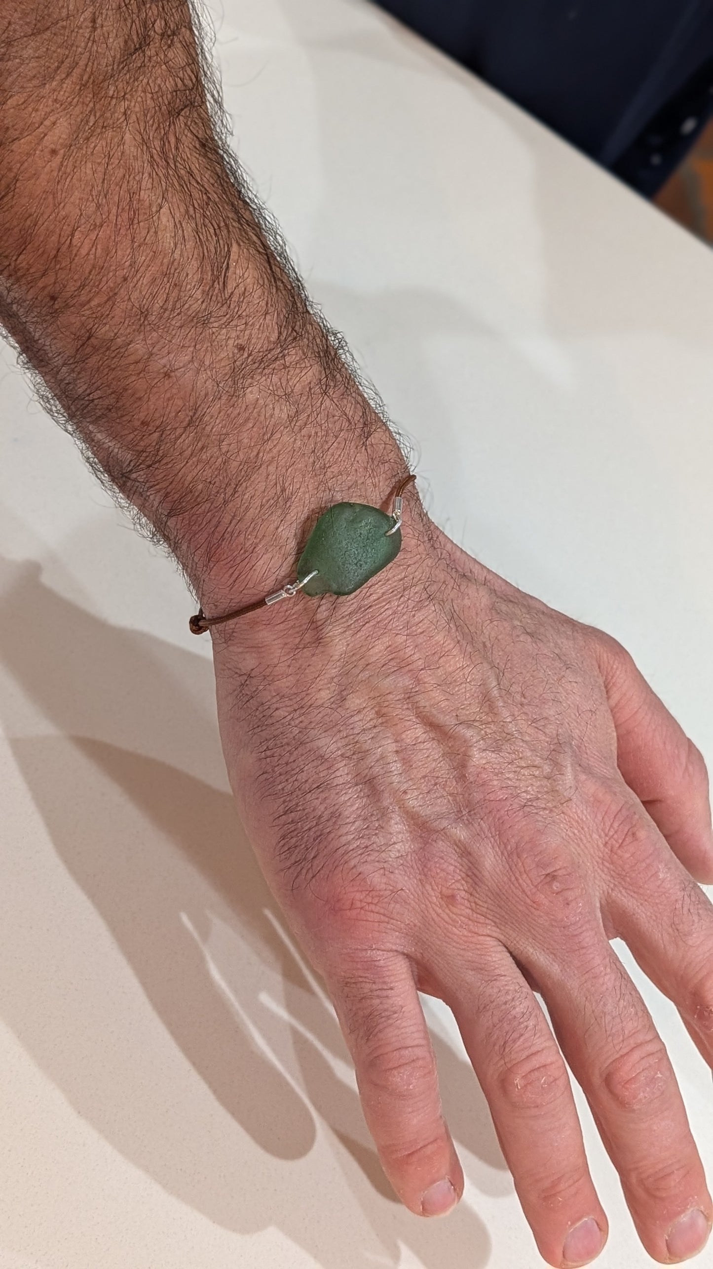 Adjustable cord bracelet with green sea glass