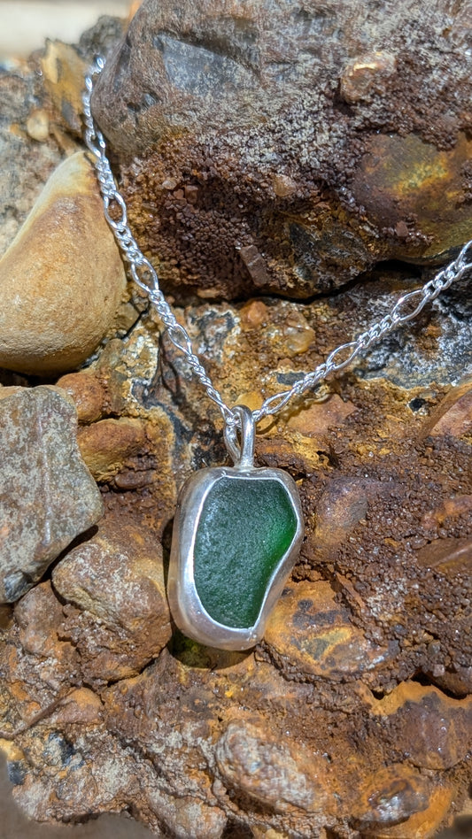 Green sea glass pendant encased in bezel with chain